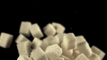 Super slow motion sugar cubes soar up and fall down. On a black background.Filmed on a high-speed camera at 1000 fps. video