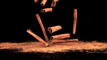 Super slow motion cinnamon sticks fall on the table. On a black background.Filmed on a high-speed camera at 1000 fps. video