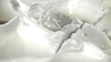 Pieces of coconut fall into the milk with splashes. Filmed on a high-speed camera at 1000 fps. High quality FullHD footage video