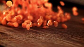 Lentils fall on a wooden plank. Filmed on a high-speed camera at 1000 fps. High quality FullHD footage video