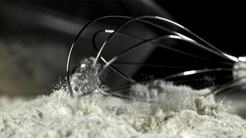 The whisk falls into the flour. Filmed on a high-speed camera at 1000 fps. High quality FullHD footage video