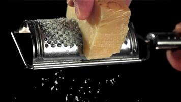 A chef grates Parmesan cheese. Filmed on a high-speed camera at 1000 fps. High quality FullHD footage video