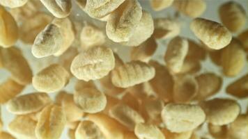 Gnocchi fly up and fall down. Filmed on a high-speed camera at 1000 fps. High quality FullHD footage video