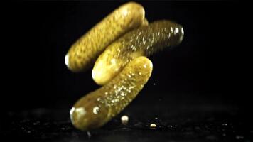 Pickled cucumbers fall with splashes. Filmed on a high-speed camera at 1000 fps. High quality FullHD footage video