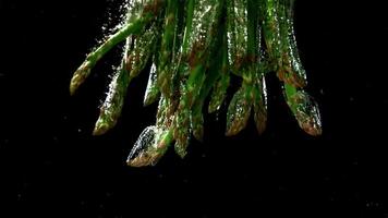 The asparagus falls under the water. Filmed is slow motion 1000 fps. High quality FullHD footage video