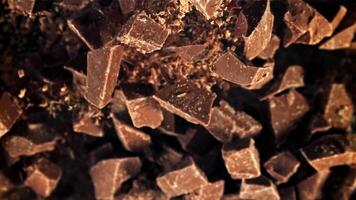 Chunks of chocolate fly up and fall down. Filmed on a high-speed camera at 1000 fps. High quality FullHD footage video