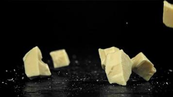 Chunks of white chocolate fall on the table. Filmed on a high-speed camera at 1000 fps. High quality FullHD footage video