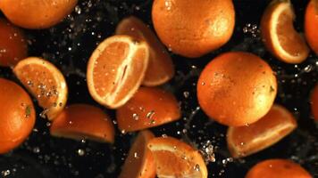 Orange slices fly up with water drops. Filmed is slow motion 1000 fps. High quality FullHD footage video