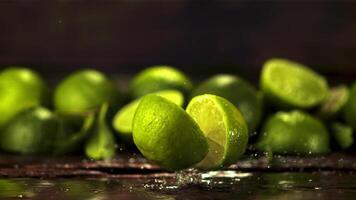 Super slow motion fresh lime falls on the table and splits in two. Against a dark background. Filmed on a high-speed camera at 1000 fps. video