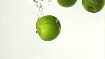 Super slow motion under the water fall fresh apples. On a white background. Filmed on a high-speed camera at 1000 fps. High quality FullHD footage video