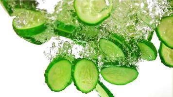 Super slow motion sliced fresh cucumber under water with air bubbles. On a white background.Filmed on a high-speed camera at 1000 fps. High quality FullHD footage video