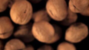 Super slow motion walnuts rise up and fall. On a black background.Filmed on a high-speed camera at 1000 fps. video