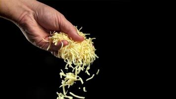 Grated cheese falls out of the cook's hand. Filmed on a high-speed camera at 1000 fps. High quality FullHD footage video