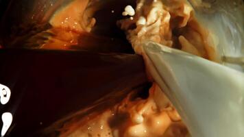 Mixing milk and coffee streams. Top view. Filmed on a high-speed camera at 1000 fps. High quality FullHD footage video