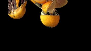 Super slow motion lemon slices under water with air bubbles. On a black background. Filmed on a high-speed camera at 1000 fps. High quality FullHD footage video