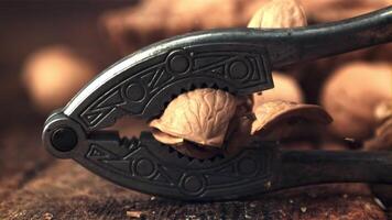Super slow motion walnut pricked nut-fol. On a wooden background. Filmed on a high-speed camera at 1000 fps. video