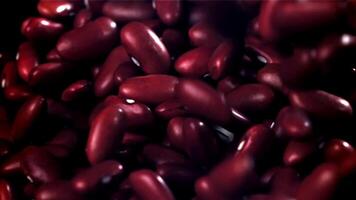 The fall of red beans. Filmed on a high-speed camera at 1000 fps. High quality FullHD footage video