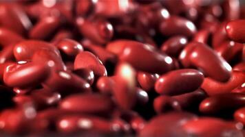 The fall of red beans. Filmed on a high-speed camera at 1000 fps. High quality FullHD footage video