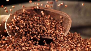 Buckwheat falling into a pile with a scoop. Filmed on a high-speed camera at 1000 fps. High quality FullHD footage video