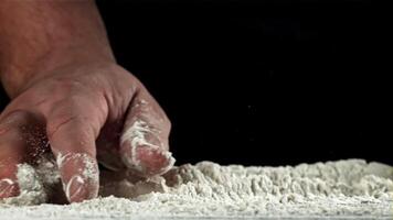 The cook runs his hand over the table with flour. Filmed on a high-speed camera at 1000 fps. High quality FullHD footage video