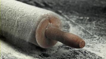 The rolling pin falls into the flour. Filmed on a high-speed camera at 1000 fps. High quality FullHD footage video