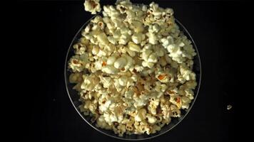 Popcorn drops into a big bowl. Filmed on a high-speed camera at 1000 fps. High quality FullHD footage video