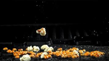 Popcorn explodes in a pan with a splash of oil. Filmed on a high-speed camera at 1000 fps. High quality FullHD footage video