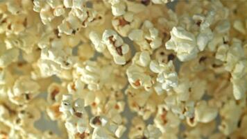 Popcorn flies up and falls down. On a light background. Filmed on a high-speed camera at 1000 fps. High quality FullHD footage video