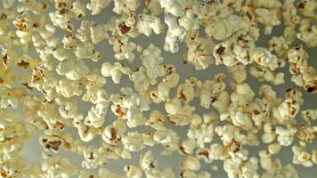 Popcorn flies up and falls down. On a light background. Filmed on a high-speed camera at 1000 fps. High quality FullHD footage video