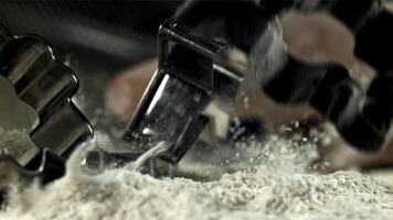 Cookie cutters fall into the flour. Filmed on a high-speed camera at 1000 fps. High quality FullHD footage video