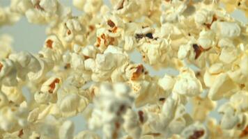 Popcorn flies up and falls down. On a light background. Filmed on a high-speed camera at 1000 fps. High quality FullHD footage video