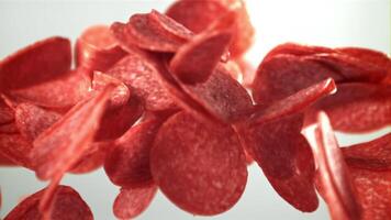 Sliced salami flies up and falls down. Filmed on a high-speed camera at 1000 fps. High quality FullHD footage video