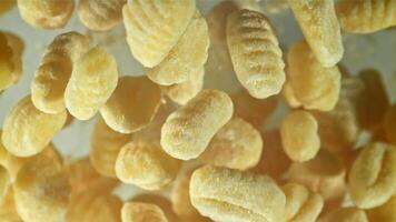 Gnocchi fly up and fall down. Filmed on a high-speed camera at 1000 fps. High quality FullHD footage video