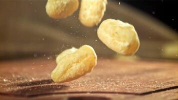 Gnocchi fall onto the cutting board. Filmed on a high-speed camera at 1000 fps. High quality FullHD footage video