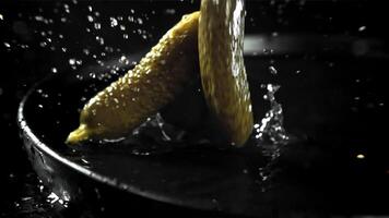 Pickled cucumbers fall with splashes. Filmed on a high-speed camera at 1000 fps. High quality FullHD footage video