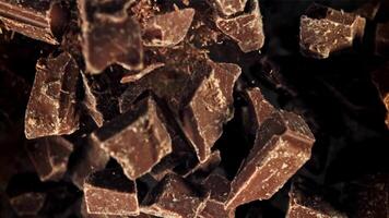 Chunks of chocolate fly up and fall down. Filmed on a high-speed camera at 1000 fps. High quality FullHD footage video