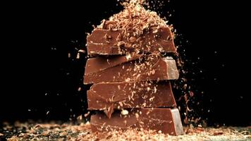 The grated chocolate falls on the chocolate slices. Filmed on a high-speed camera at 1000 fps. High quality FullHD footage video