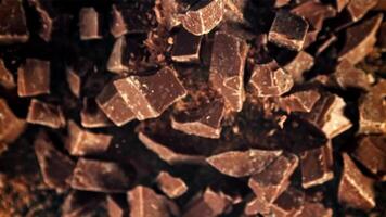 Chunks of chocolate fly up and fall down. Filmed on a high-speed camera at 1000 fps. High quality FullHD footage video