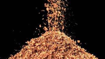 The fall of grated chocolate. Filmed on a high-speed camera at 1000 fps. High quality FullHD footage video