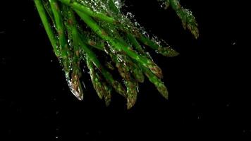 The asparagus falls under the water. Filmed is slow motion 1000 fps. High quality FullHD footage video