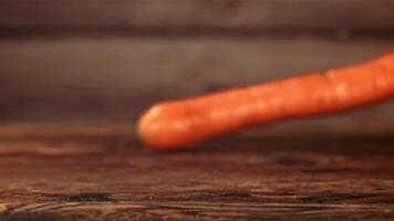 Falling carrots on the table. Filmed is slow motion 1000 fps. High quality FullHD footage video