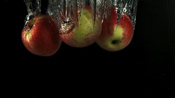 Apples fall under water. Filmed is slow motion 1000 fps. High quality FullHD footage video