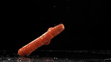 Falling carrots on the table. Filmed is slow motion 1000 fps. High quality FullHD footage video