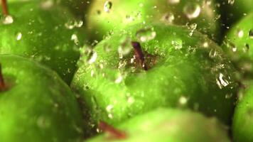 Super slow motion water droplets fall on fresh apples. Macro background. Filmed on a high-speed camera at 1000 fps. High quality FullHD footage video