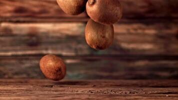 Super slow motion ripe kiwi fall on the table. On a wooden background. Filmed on a high-speed camera at 1000 fps.High quality FullHD footage video