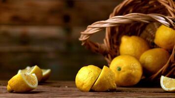 Super slow motion lemon falls on the table and breaks into pieces. On a wooden background.Filmed on a high-speed camera at 1000 fps. High quality FullHD footage video