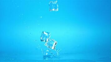 Super slow motion ice cubes will fall on the table. On a blue background.Filmed on a high-speed camera at 1000 fps. video
