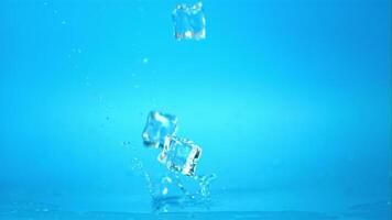 Super slow motion ice cubes will fall on the table. On a blue background.Filmed on a high-speed camera at 1000 fps. video