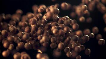 Super slow motion of peppercorns is tossed up against a black background. Filmed on a high-speed camera at 1000 fps. video