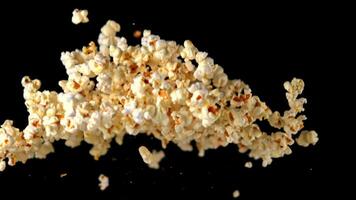 Super slow motion popcorn on a black background. Filmed on a high-speed camera at 1000 fps. High quality FullHD footage video
